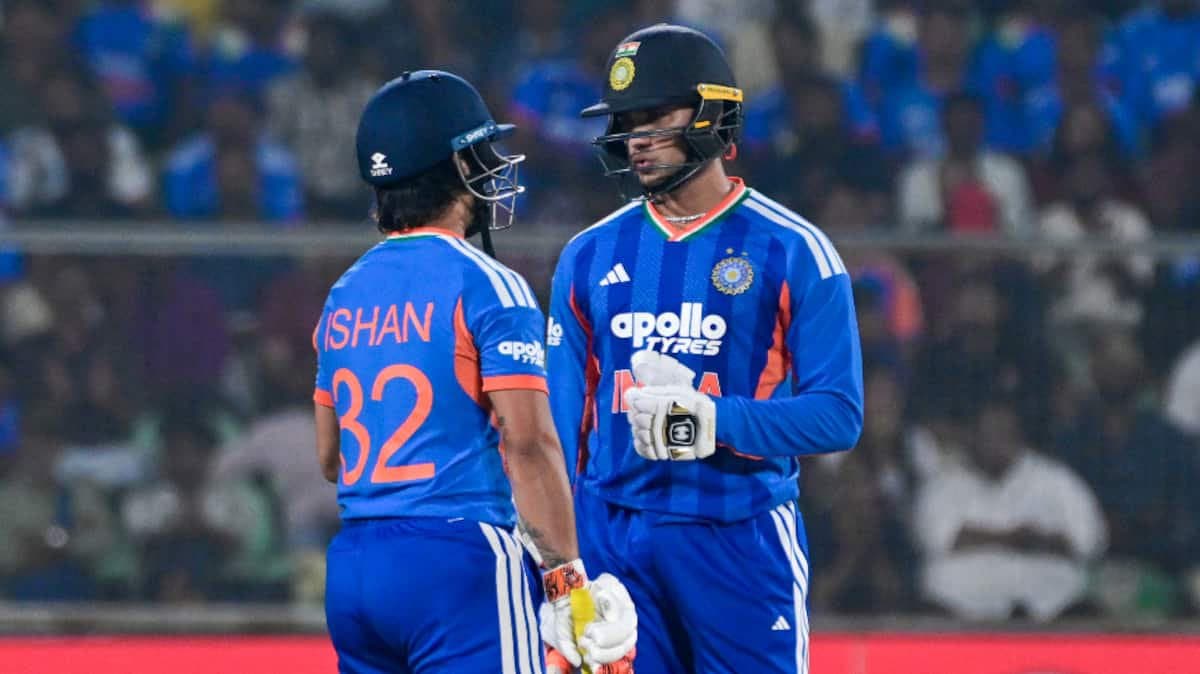 Ishan Kishan and Abhishek Sharma speak in the middle after Kishan's run-out during the first ODI between India and England, with both batters wearing India's blue jerseys.